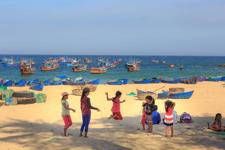 砂浜で縄跳びで遊ぶ子供たち